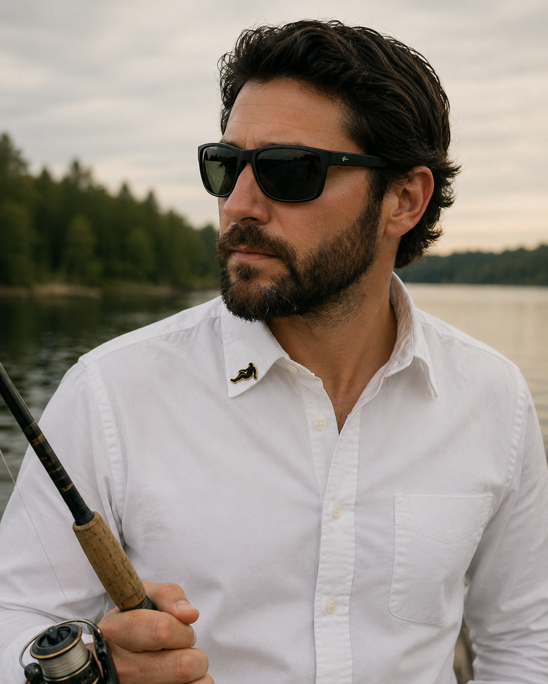 Man wearing Bigfoot resting hat clip on shirt collar while fishing